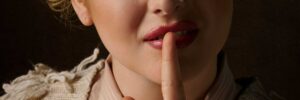 woman shushing telling secrets and lies